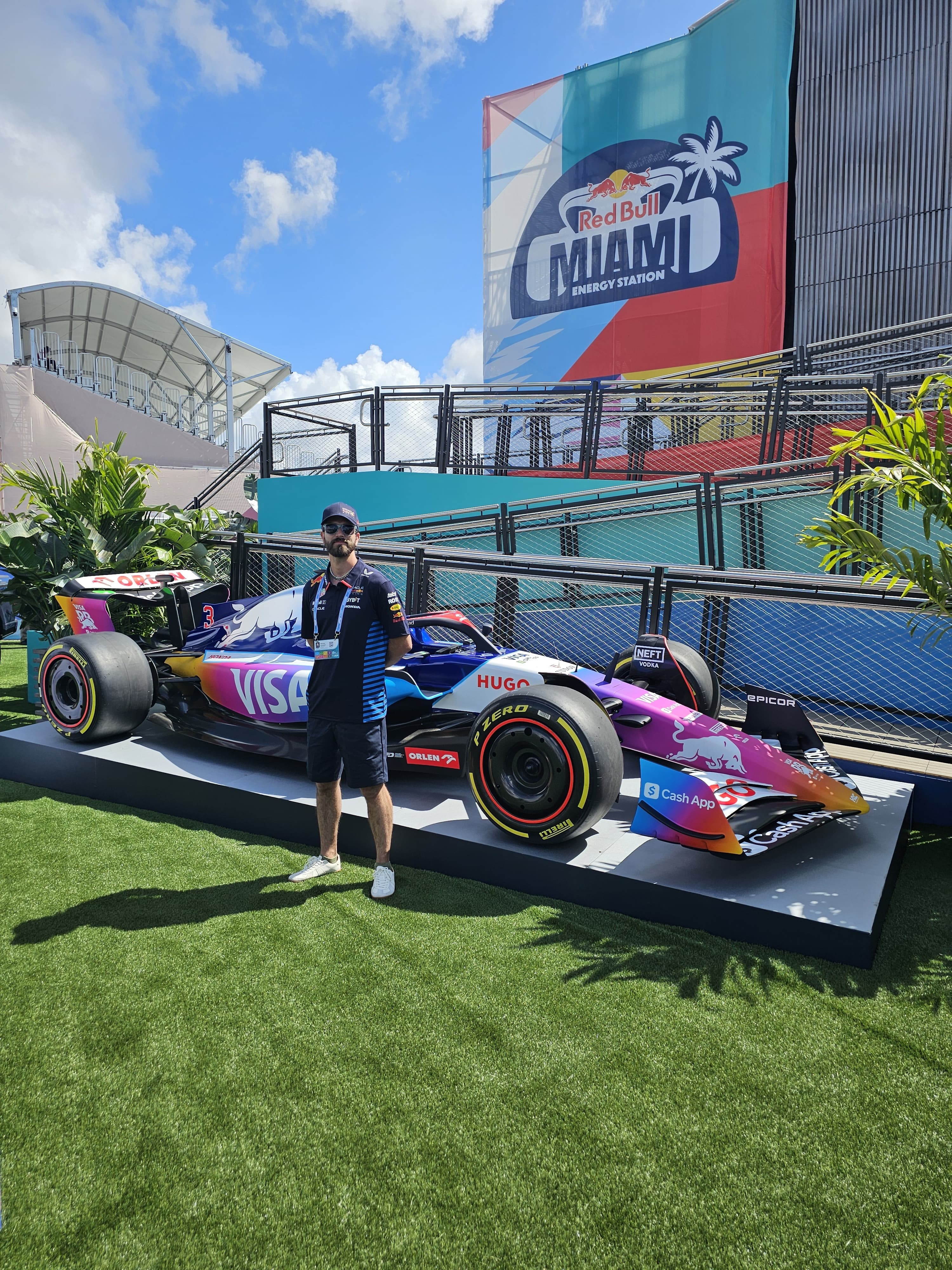 A brand ambassador working beside a Formula 1 car at a branded event activation